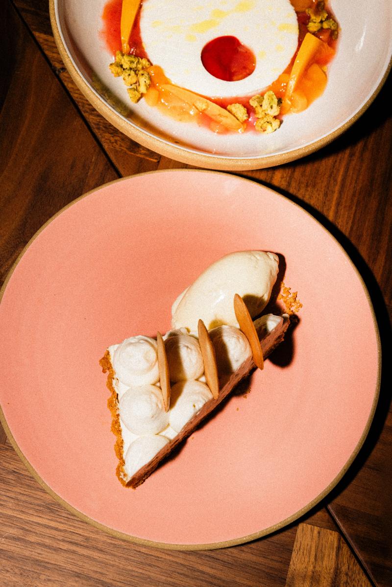 A slice of tart on a pink plate
