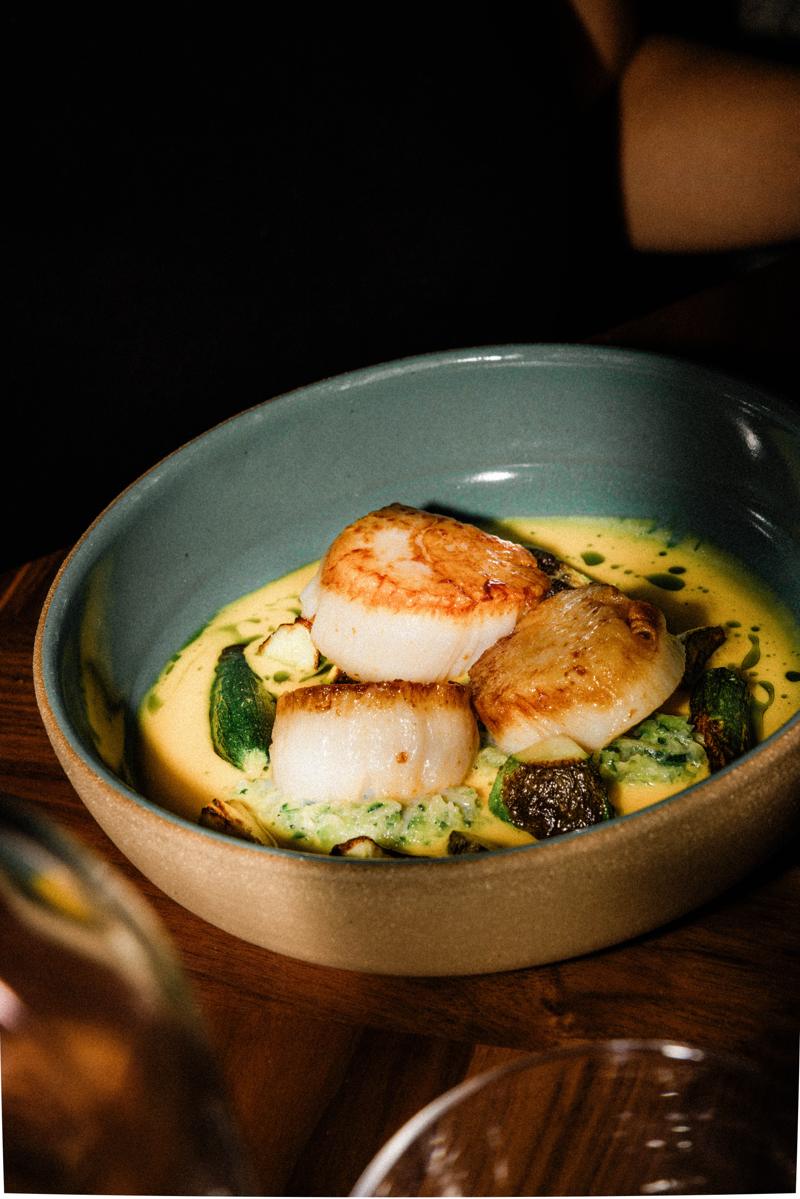 Seared scallops in a ceramic bowl